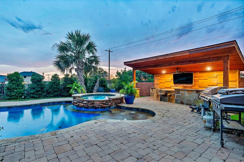 Pool, spa and cabana bar at dusk
