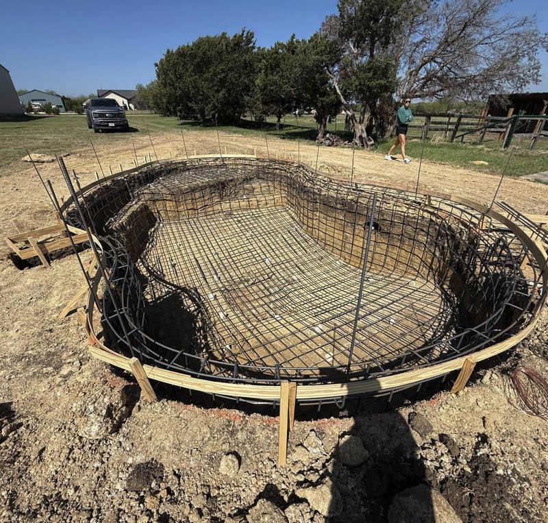 Freeform pool excavation with the rebar cage tied and forms set