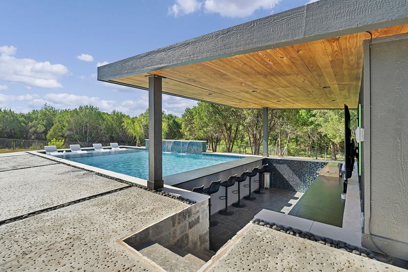 Swim up bar beside a modern pavilion